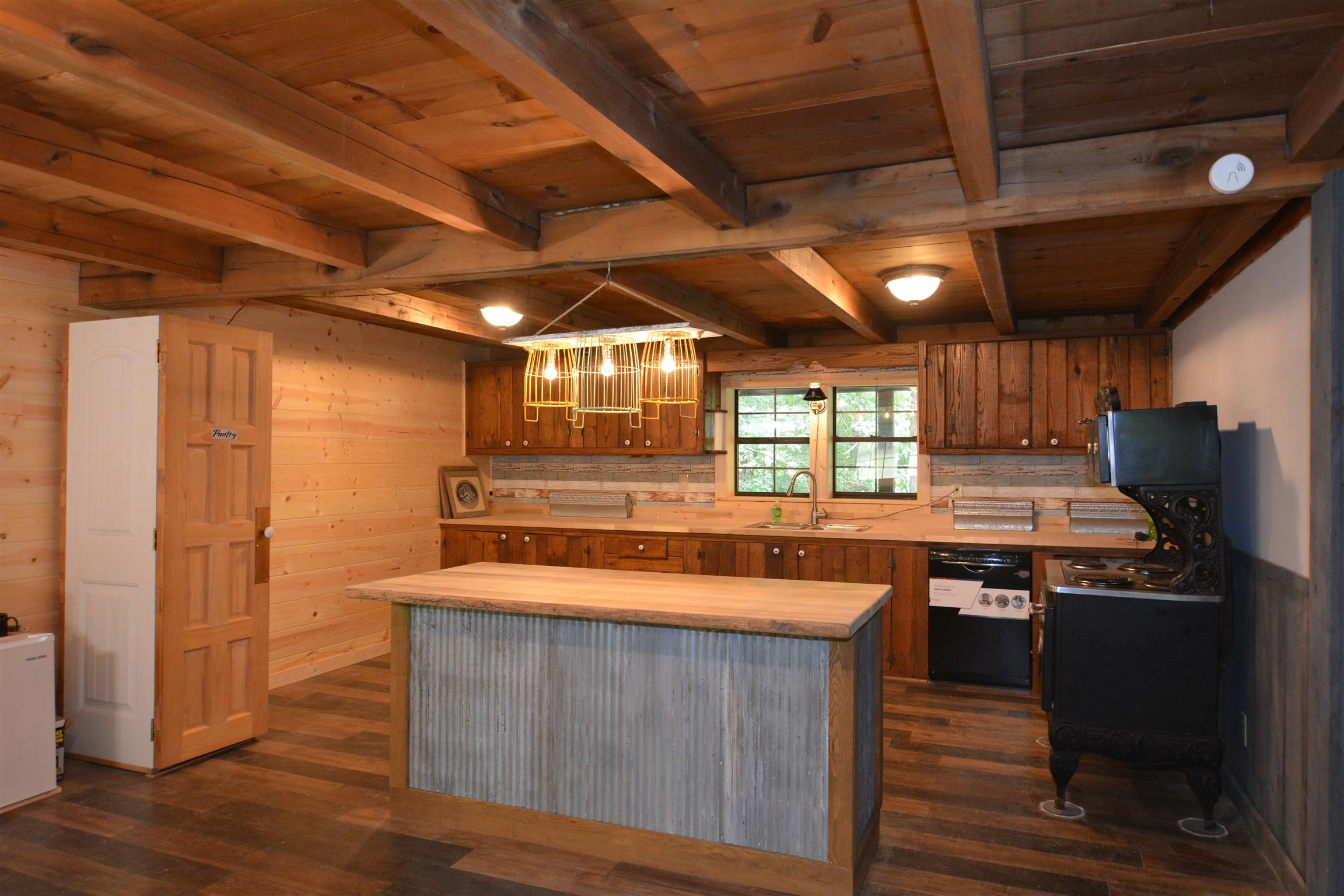 The country kitchen has an island and pantry that can be moved wherever you want them. 