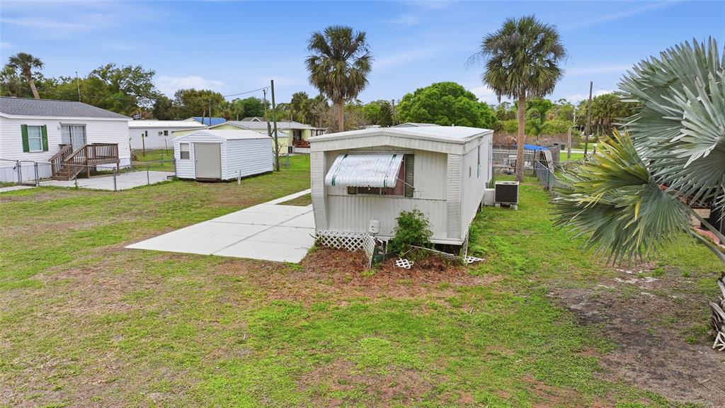 11923 Southwest Loop Terrace Arcadia, FL 34269 - Photo 49 of 50 a view of a house with a yard and table