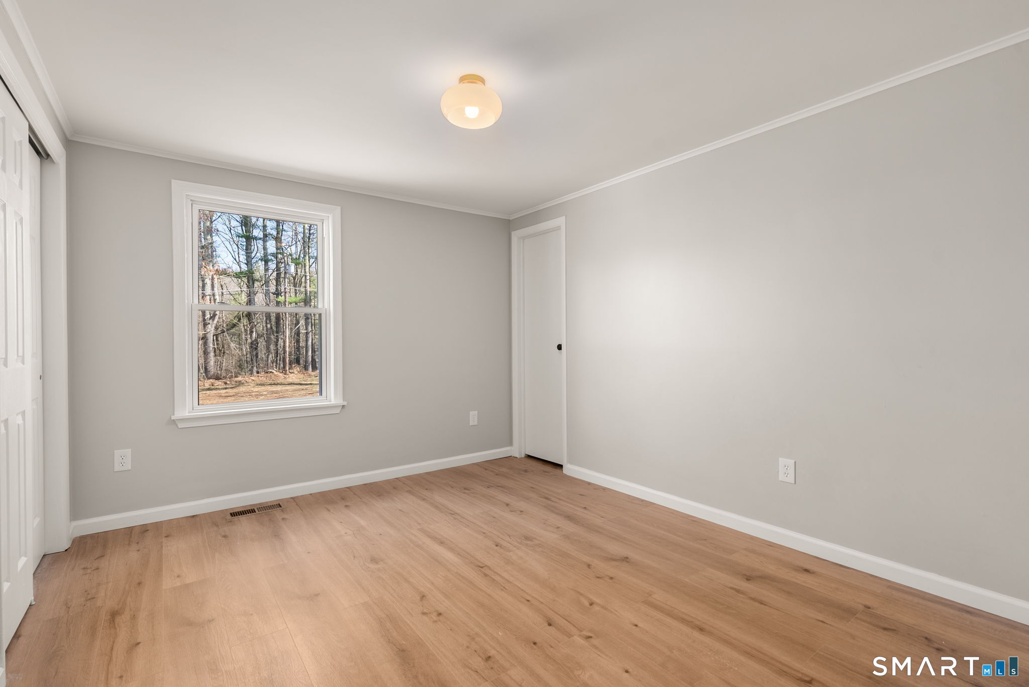 89 Bradway Road Stafford, CT 06076 - Photo 30 of 39 an empty room with wooden floor and windows