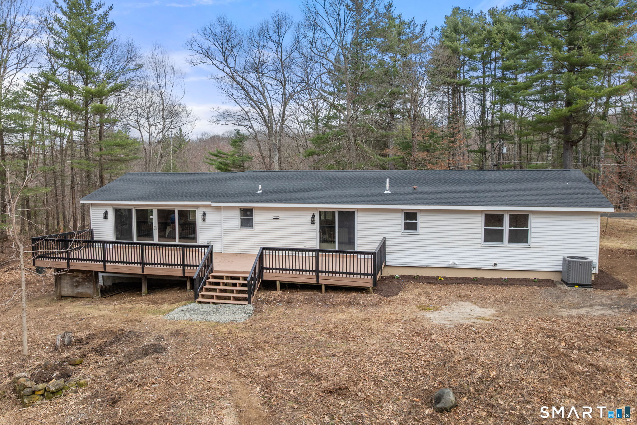 89 Bradway Road Stafford, CT 06076 - Photo 32 of 39 a view of a house with a yard and sitting area