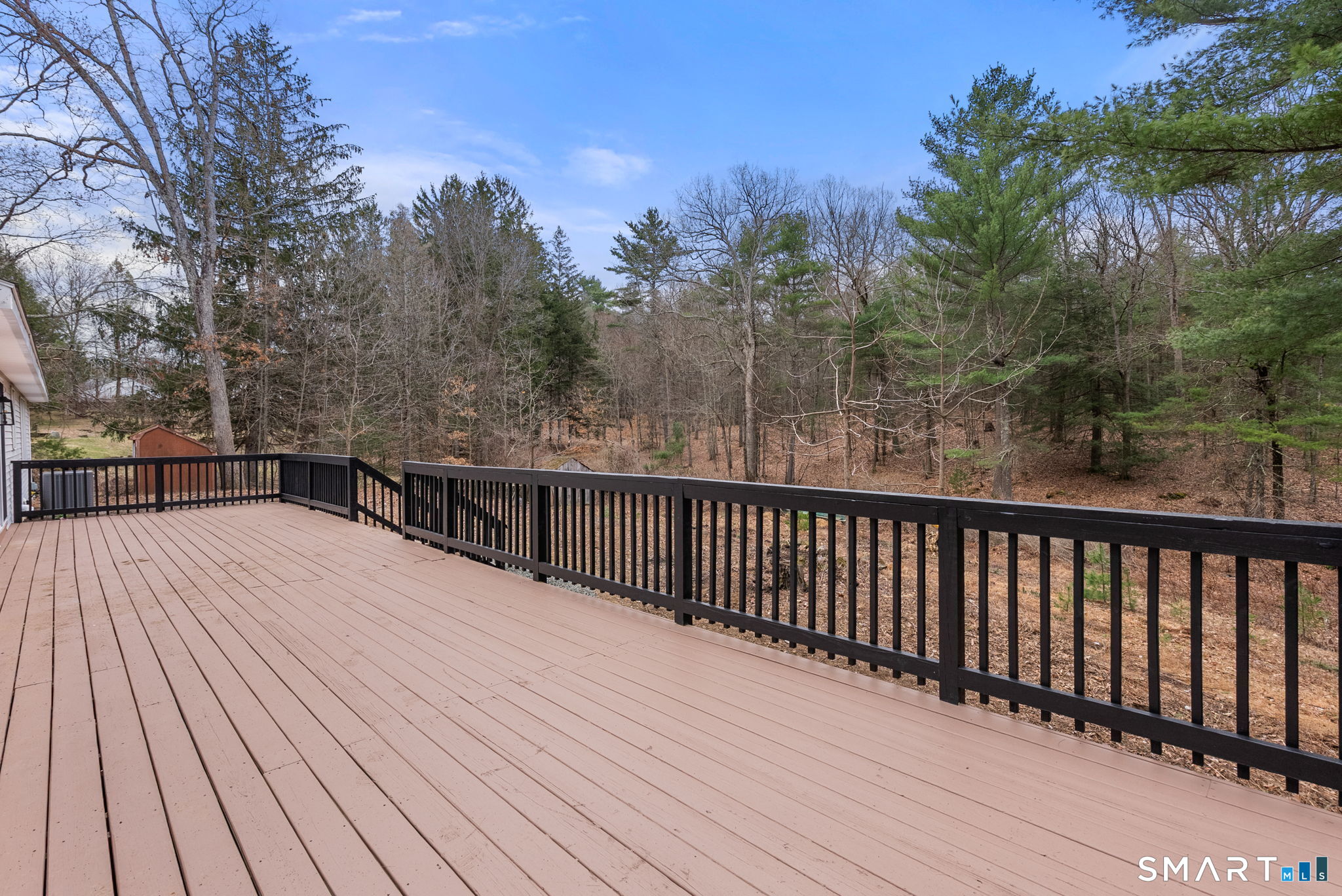 89 Bradway Road Stafford, CT 06076 - Photo 33 of 39 a balcony with wooden floor and trees in the background