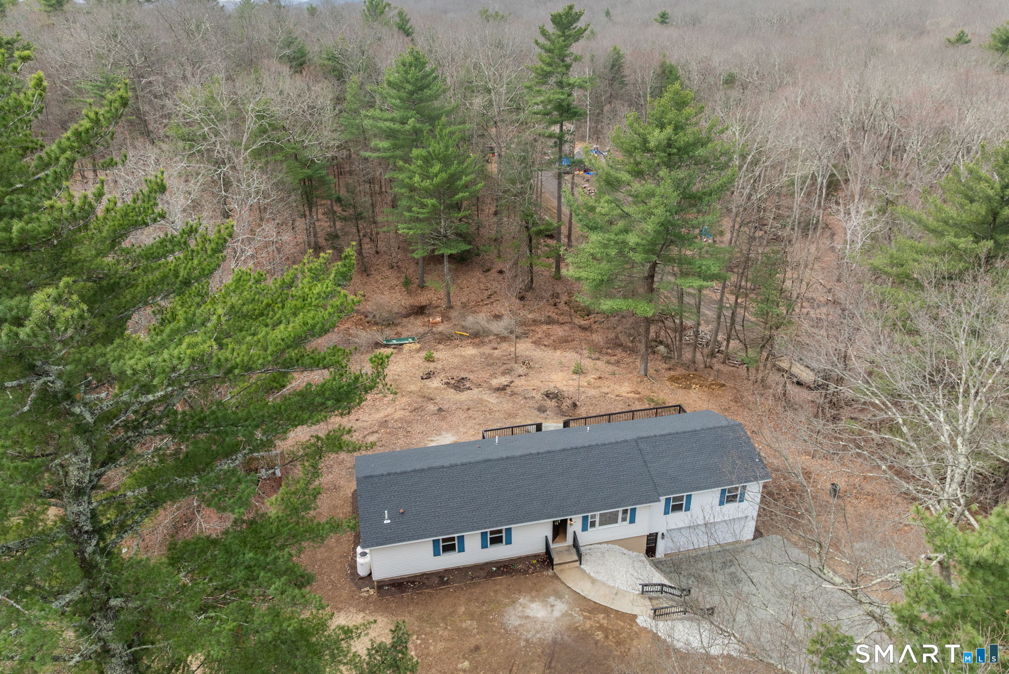 89 Bradway Road Stafford, CT 06076 - Photo 37 of 39 an aerial view of a house with yard and trees in the background