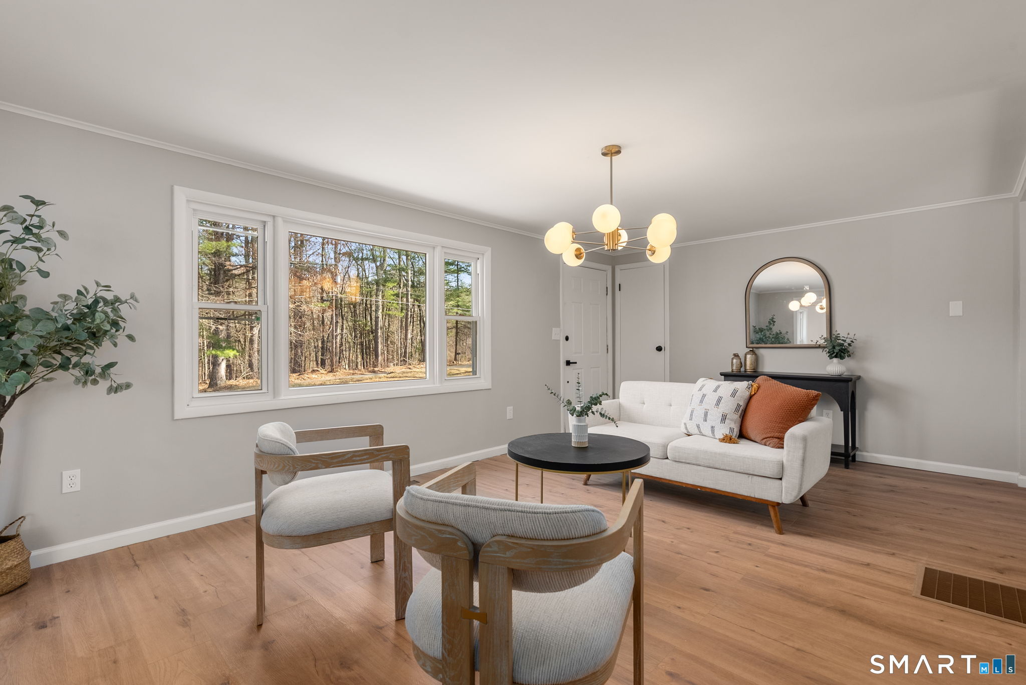 89 Bradway Road Stafford, CT 06076 - Photo 4 of 39 a living room with furniture a chandelier and a window