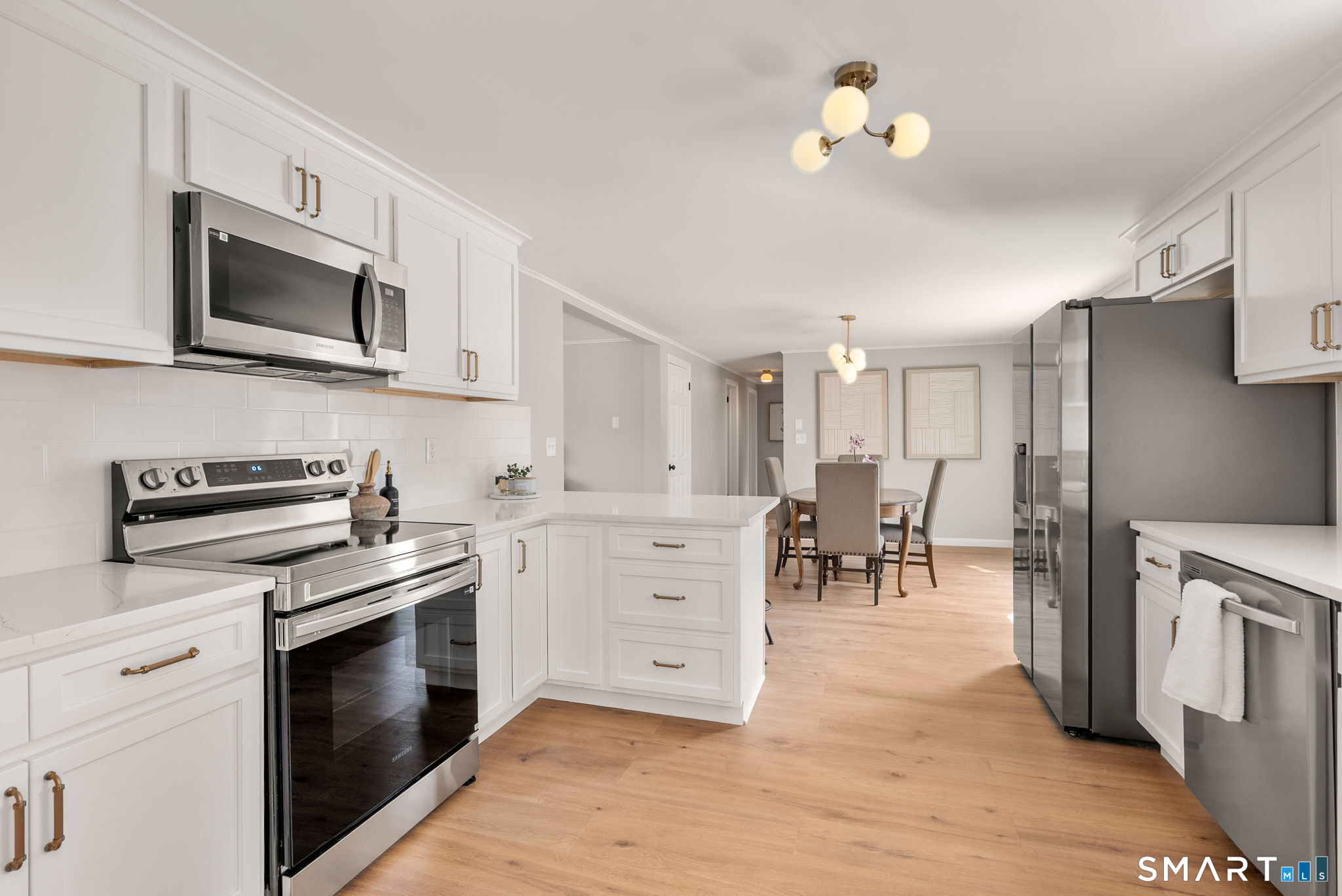 89 Bradway Road Stafford, CT 06076 - Photo 7 of 39 a kitchen with white cabinets and stainless steel appliances