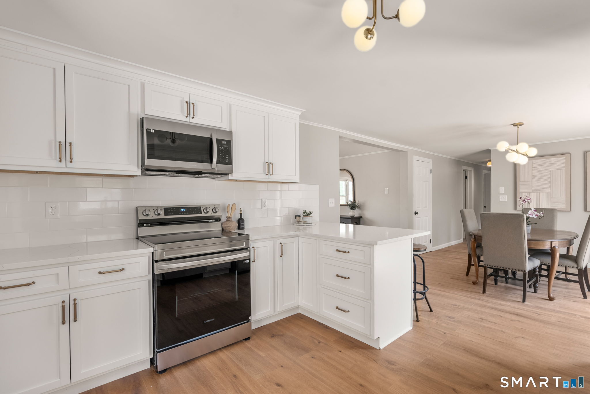 89 Bradway Road Stafford, CT 06076 - Photo 8 of 39 a kitchen with granite countertop a stove top oven microwave and cabinets