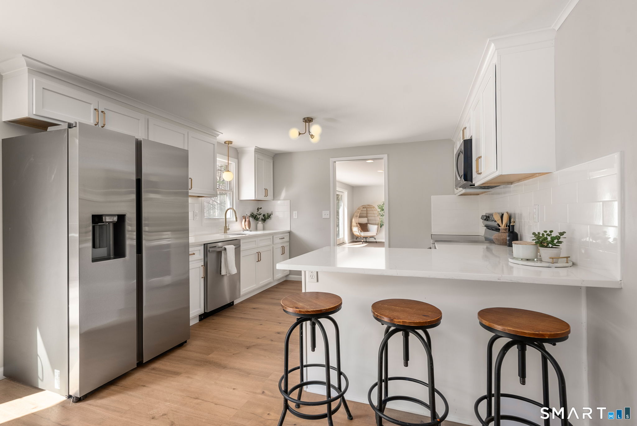 89 Bradway Road Stafford, CT 06076 - Photo 10 of 39 a kitchen with stainless steel appliances granite countertop a dining table chairs refrigerator and sink