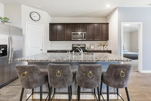a bedroom with a bed chair and a window