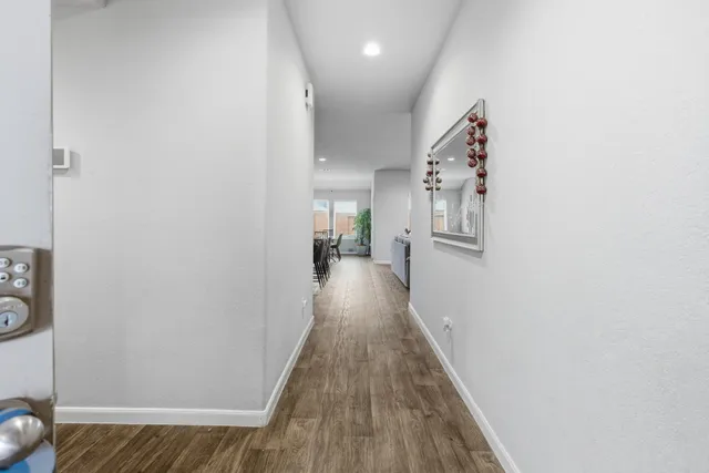 a living room with furniture a flat screen tv and kitchen view