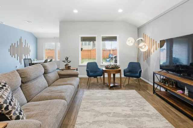 a kitchen with stainless steel appliances granite countertop a stove a sink dishwasher and microwave oven with wooden floor