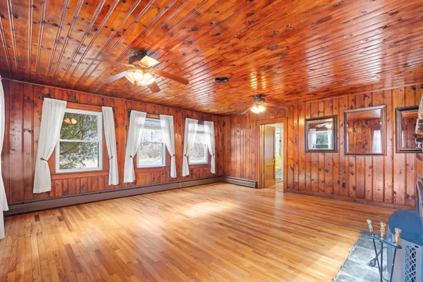 a living room with a fireplace and wooden floor