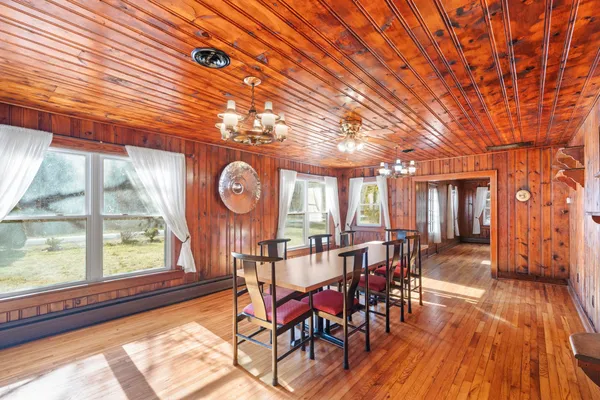 a view of a dining room with furniture and chandelier