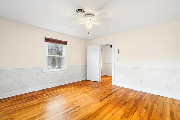 a view of a room with window and wooden floor