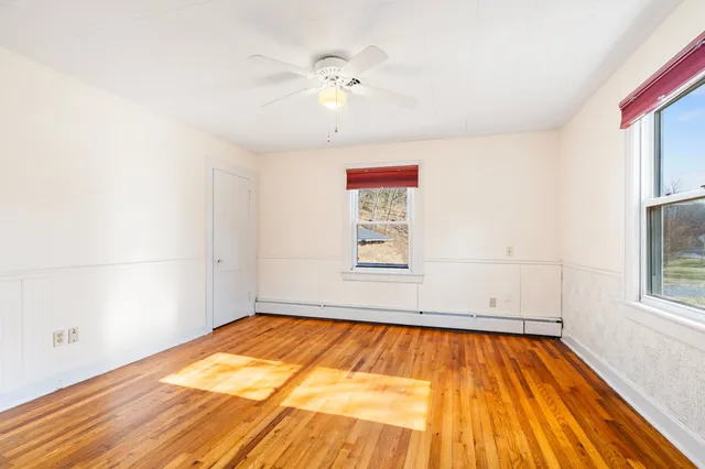 a view of a house with wooden fence