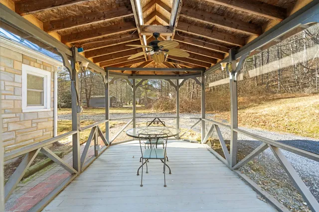 a view of a large house with a large tree and a yard