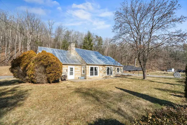 a view of a house with a yard covered with snow in the background