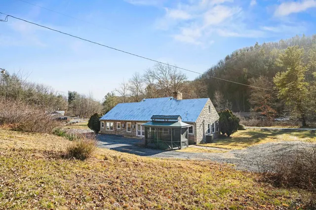 a view of a backyard with wooden fence