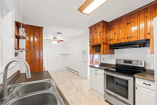 a kitchen with stainless steel appliances granite countertop a stove and a sink