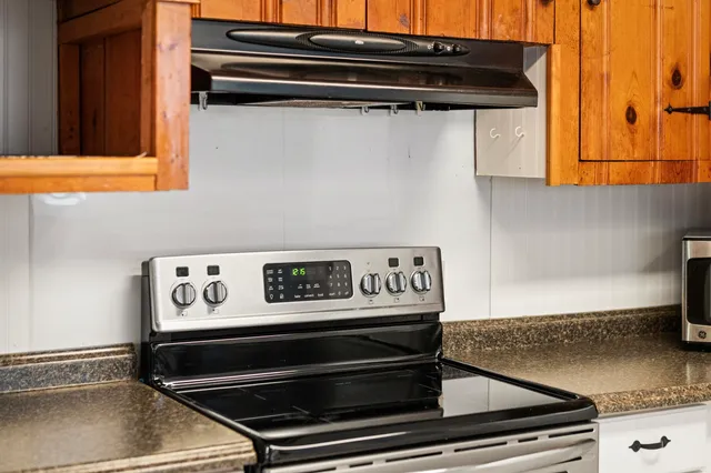 a stove top oven sitting inside of a kitchen
