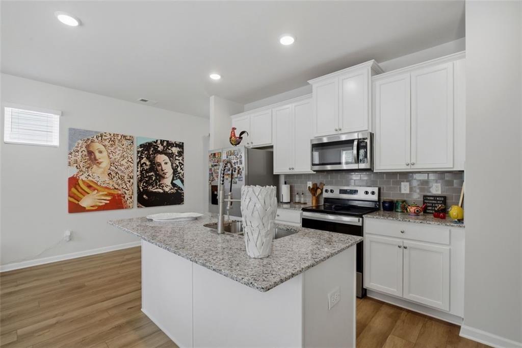 1242 Riverstone Road Jonesboro, GA 30238 - Photo 11 of 38 a kitchen with sink a microwave and cabinets