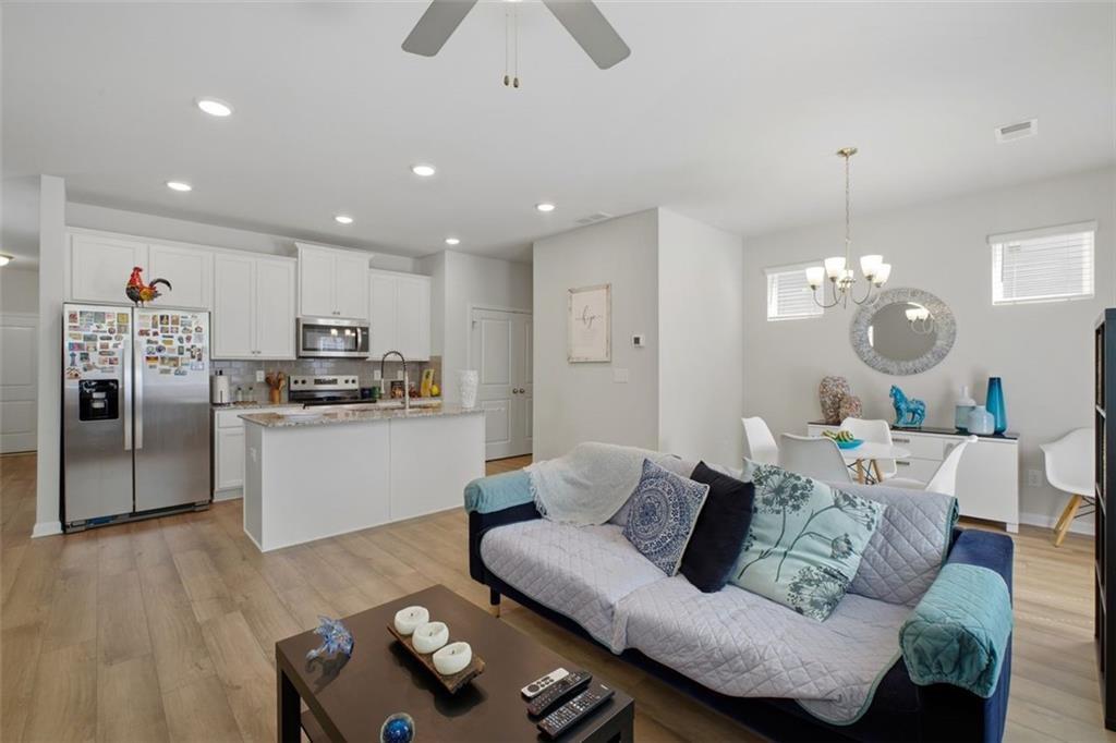 1242 Riverstone Road Jonesboro, GA 30238 - Photo 14 of 38 a living room with furniture kitchen and a chandelier