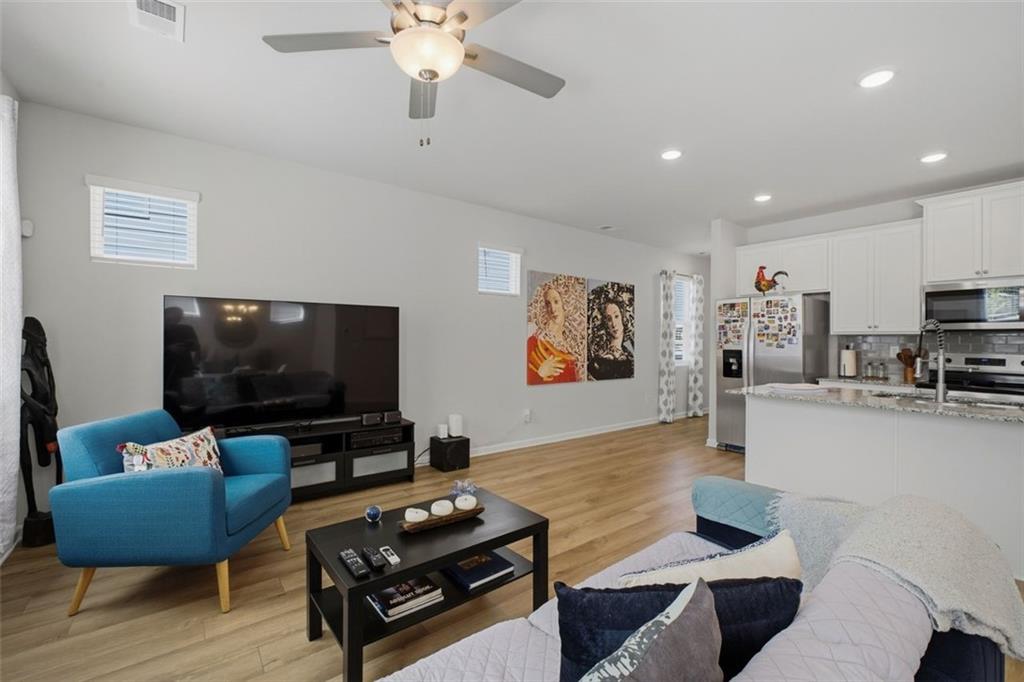 1242 Riverstone Road Jonesboro, GA 30238 - Photo 15 of 38 a living room with furniture and a flat screen tv