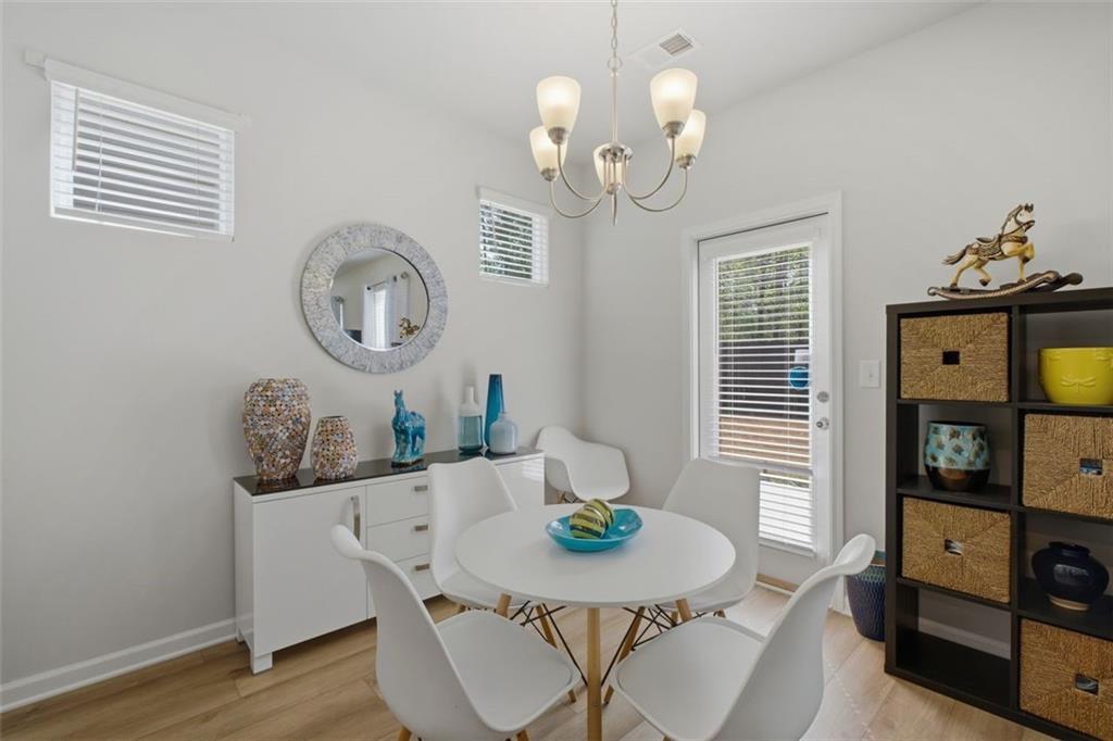 1242 Riverstone Road Jonesboro, GA 30238 - Photo 16 of 38 a view of a dining room with furniture window and wooden floor