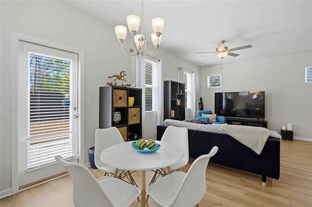 1242 Riverstone Road Jonesboro, GA 30238 - Photo 17 of 38 a view of a dining room with furniture a chandelier and wooden floor