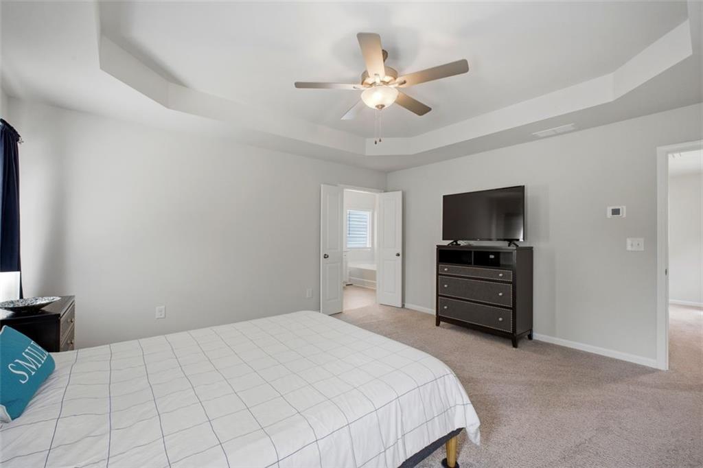 1242 Riverstone Road Jonesboro, GA 30238 - Photo 22 of 38 a bedroom with a bed and a flat screen tv