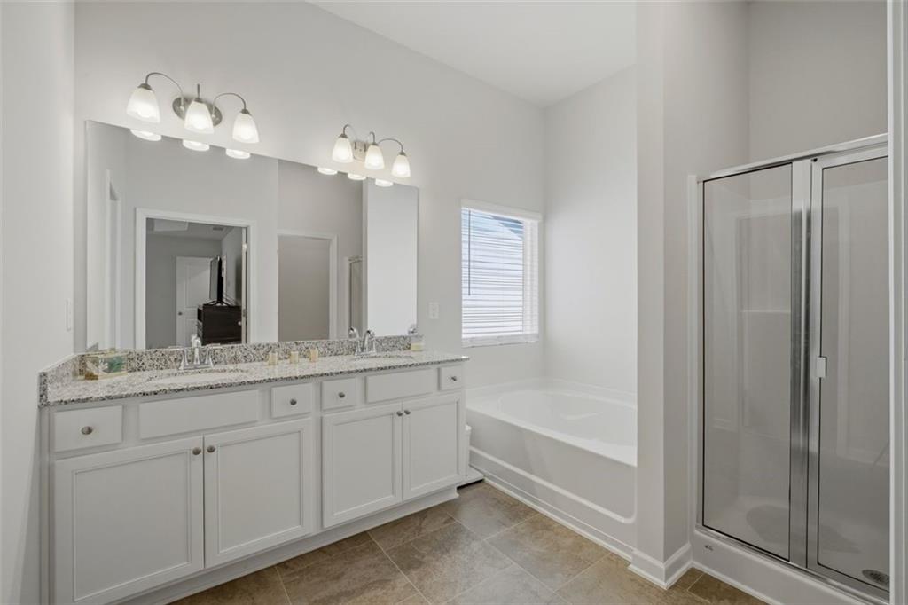 1242 Riverstone Road Jonesboro, GA 30238 - Photo 23 of 38 a bathroom with a double vanity sink and a mirror
