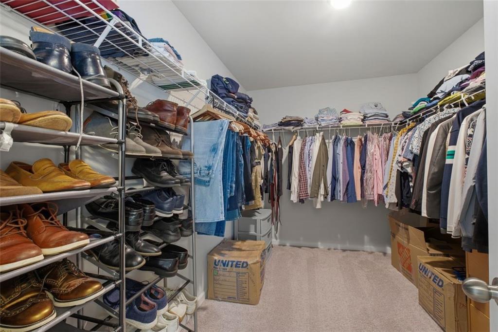 1242 Riverstone Road Jonesboro, GA 30238 - Photo 25 of 38 a view of walk in closet with clothes and shoes