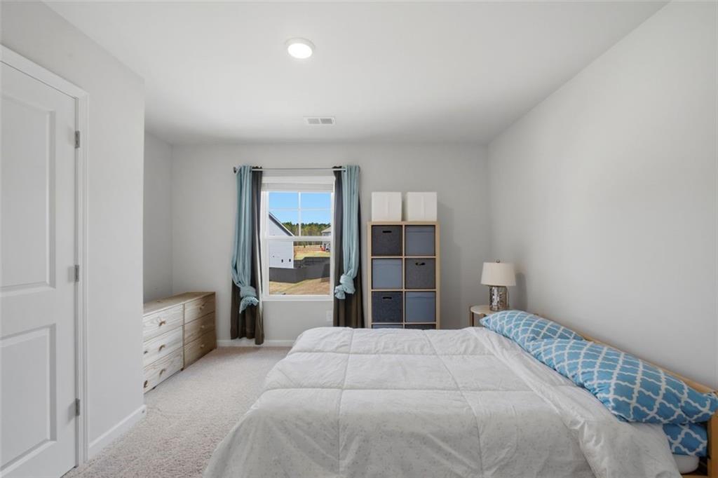 1242 Riverstone Road Jonesboro, GA 30238 - Photo 28 of 38 a bedroom with a bed and a cabinets