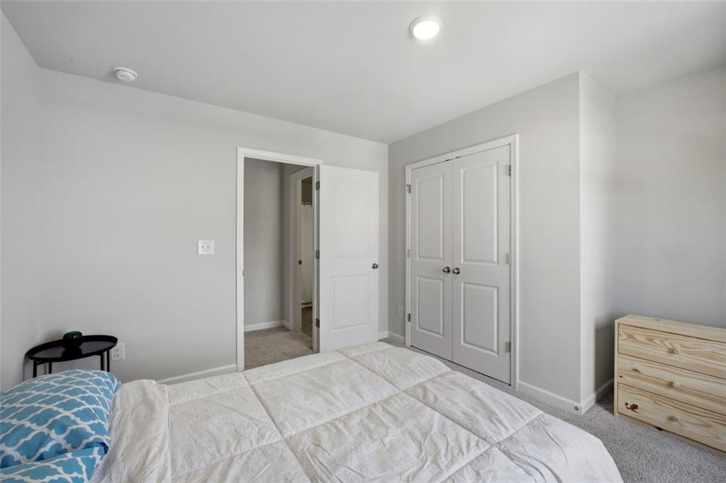 1242 Riverstone Road Jonesboro, GA 30238 - Photo 29 of 38 a bedroom with a bed and a closet