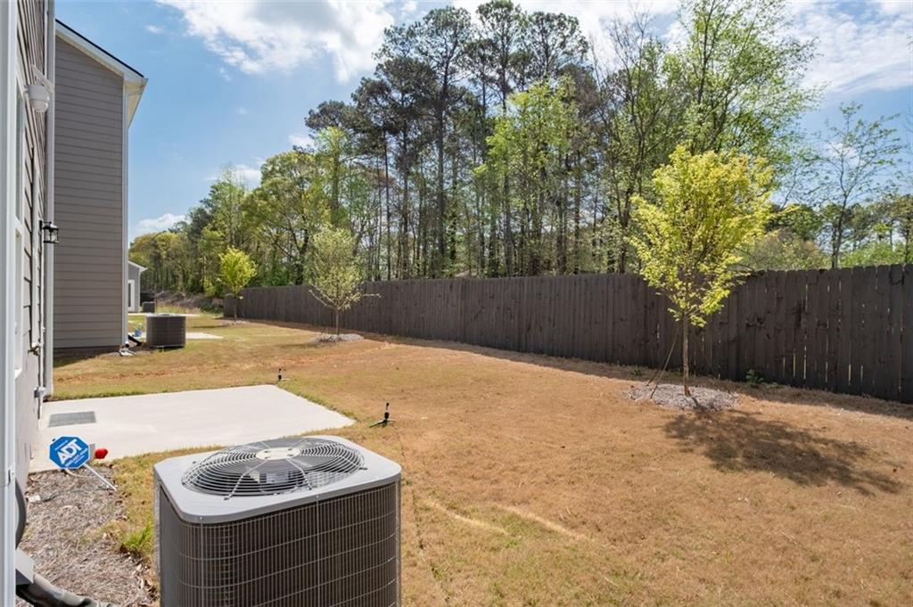 1242 Riverstone Road Jonesboro, GA 30238 - Photo 31 of 38 a backyard of a house with lots of green space