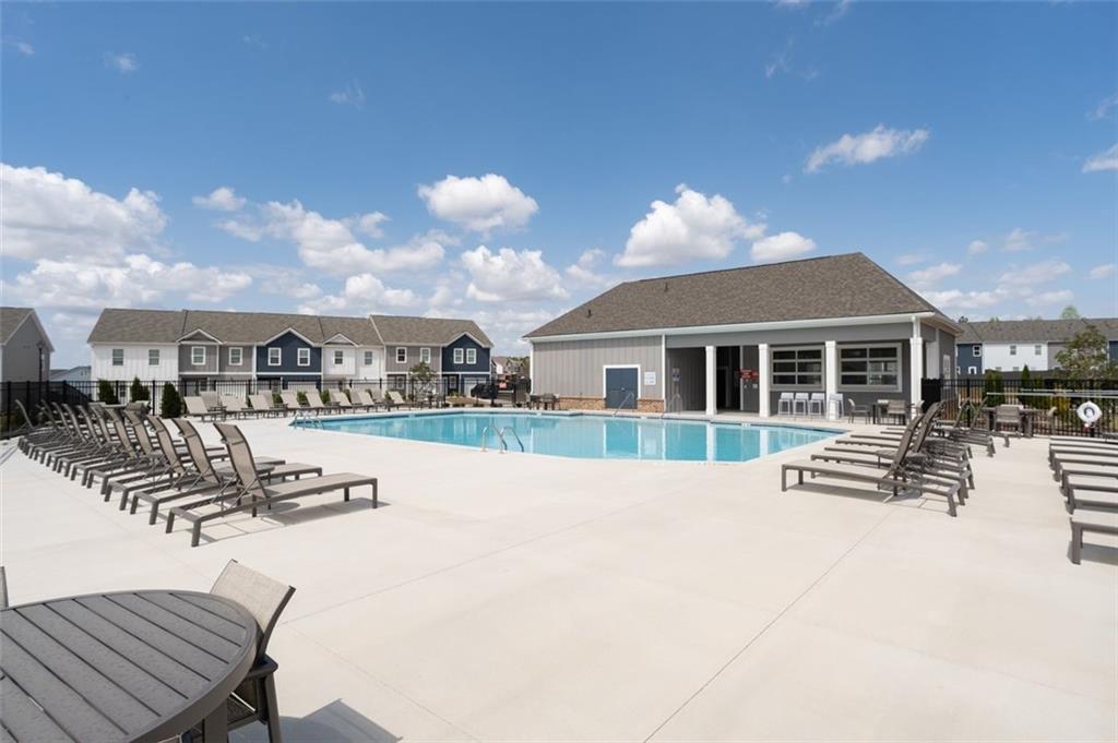 1242 Riverstone Road Jonesboro, GA 30238 - Photo 36 of 38 a view of house with swimming pool and sitting area