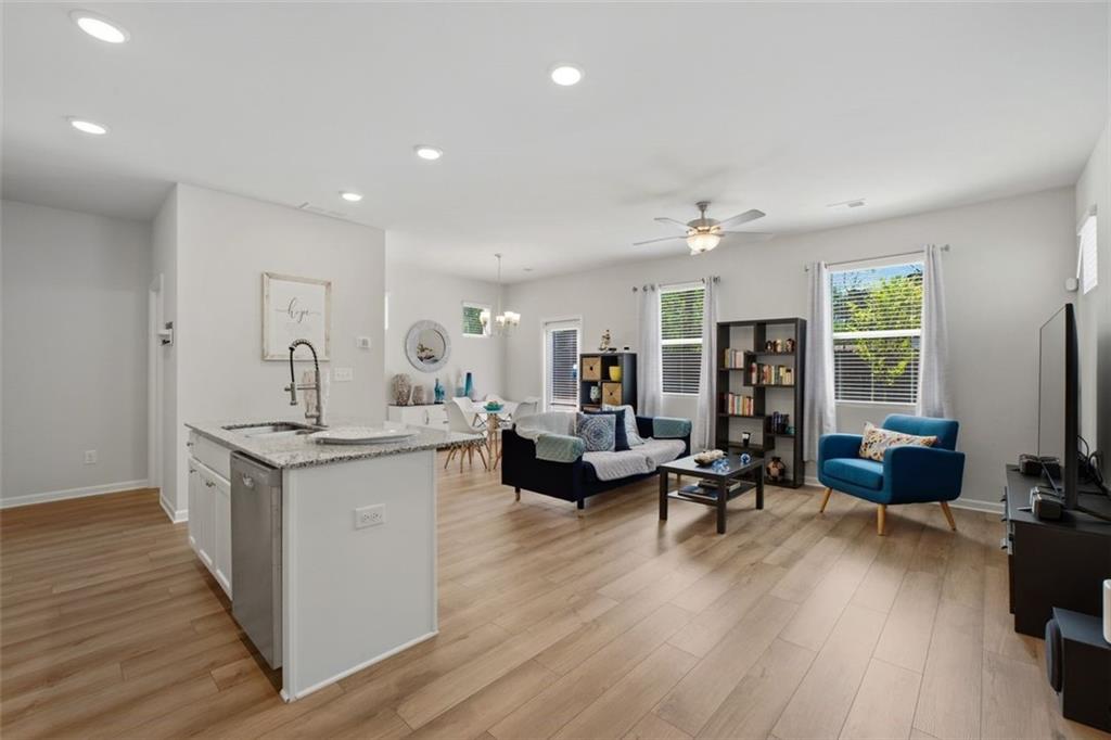 1242 Riverstone Road Jonesboro, GA 30238 - Photo 7 of 38 a living room with furniture and a wooden floor