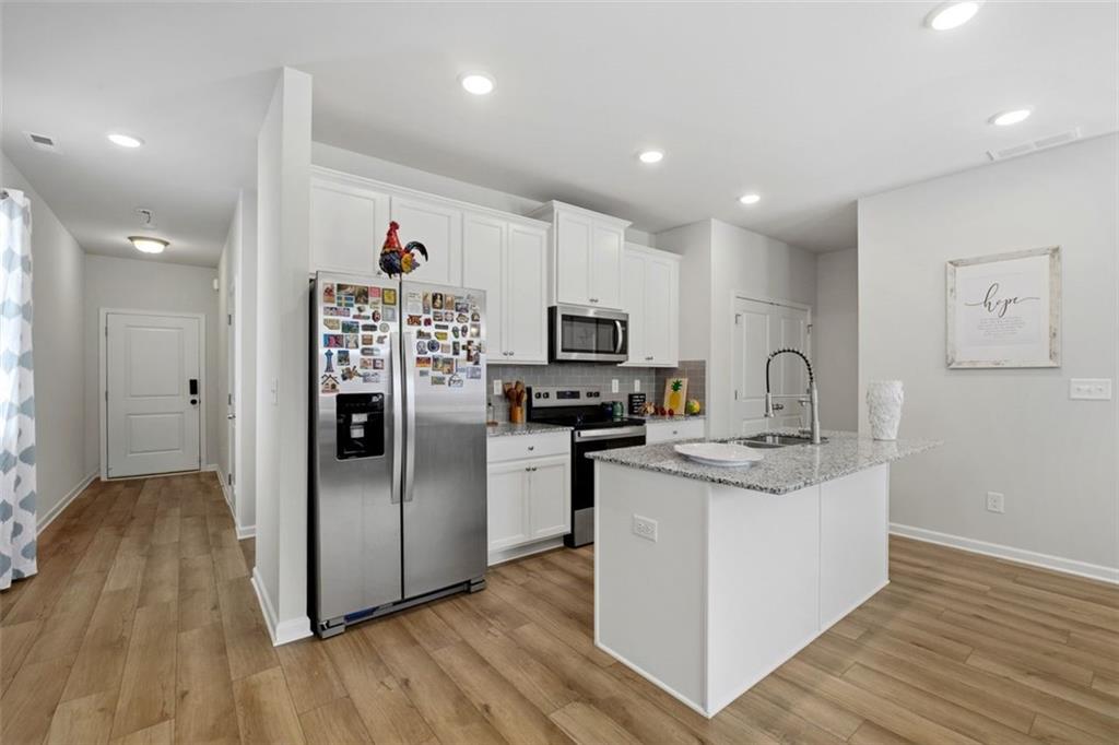 1242 Riverstone Road Jonesboro, GA 30238 - Photo 8 of 38 a kitchen with stainless steel appliances granite countertop a refrigerator and a sink