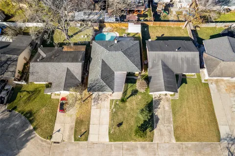 an aerial view of a house with a swimming pool