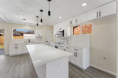 a kitchen with cabinets a sink and wooden floor