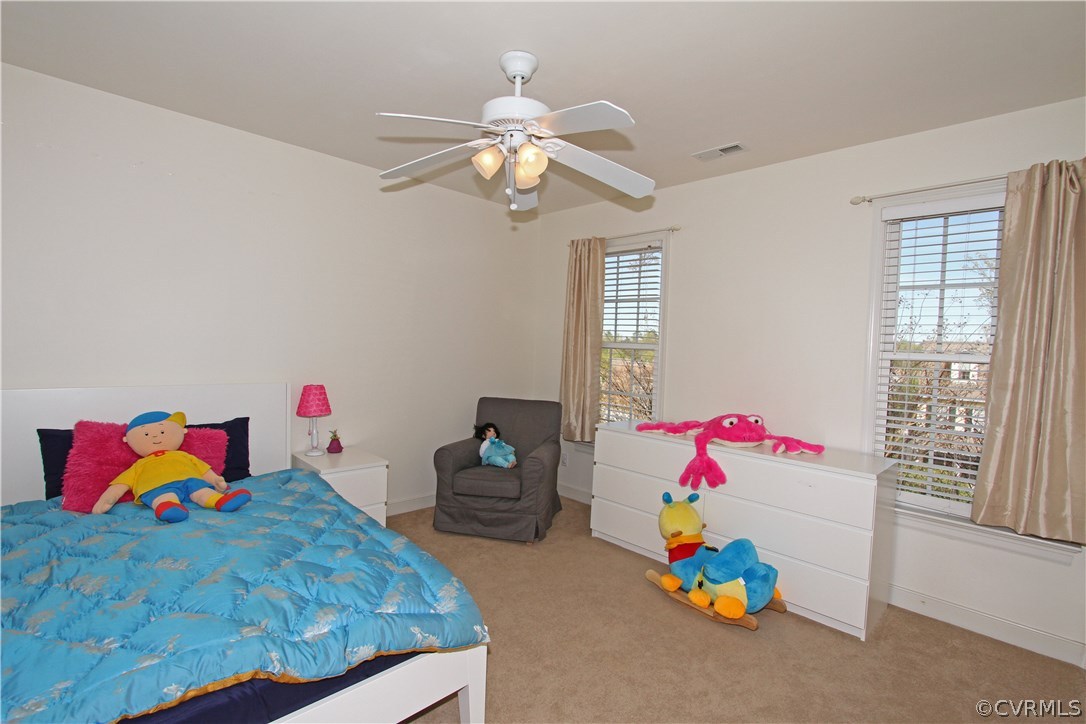 1106 Goswick Ridge Road Midlothian, VA 23114 - Photo 11 of 21 a bedroom with a bed and a chandelier
