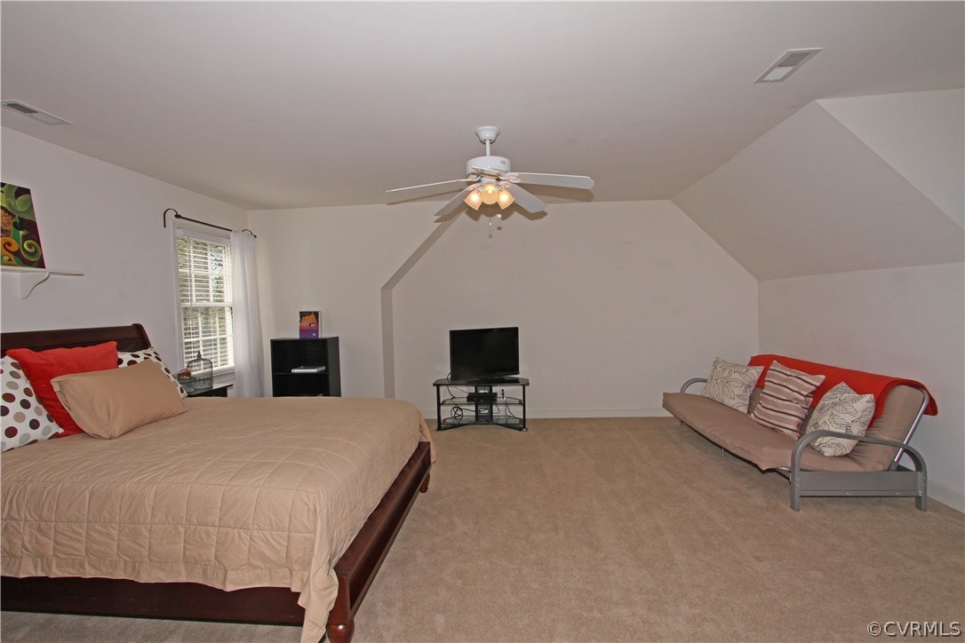 1106 Goswick Ridge Road Midlothian, VA 23114 - Photo 12 of 21 a spacious bedroom with a bed and a chandelier
