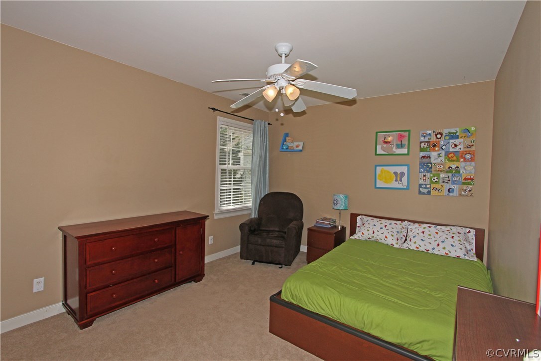 1106 Goswick Ridge Road Midlothian, VA 23114 - Photo 10 of 21 a bedroom with a bed and a chandelier