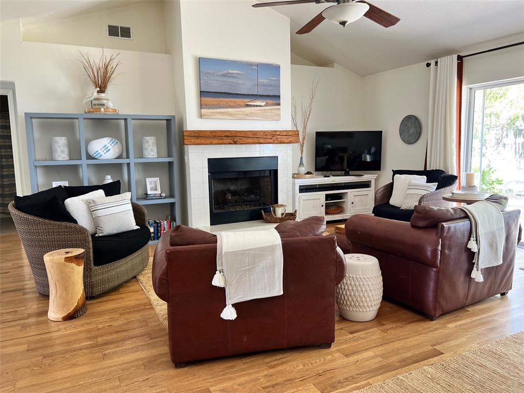 12595 Southeast Sunset Harbor Road Weirsdale, FL 32195 - Photo 7 of 25 a living room with furniture fireplace and flat screen tv
