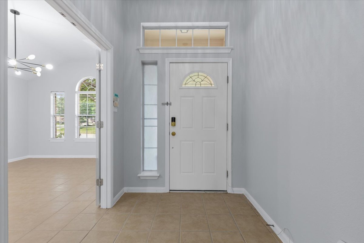 17812 Masi Loop Pflugerville, TX 78660 - Photo 6 of 38 Entryway featuring a white paneled door with an arched decorative glass insert and a transom window above