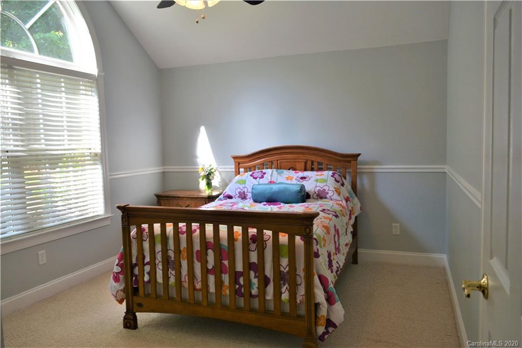 121 Spring Branch Road Fort Mill, SC 29715 - Photo 11 of 17 a bed sitting in a bedroom next to a window