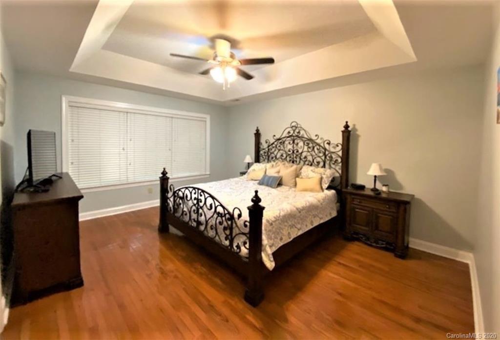 121 Spring Branch Road Fort Mill, SC 29715 - Photo 12 of 17 a bedroom with a bed and a chandelier