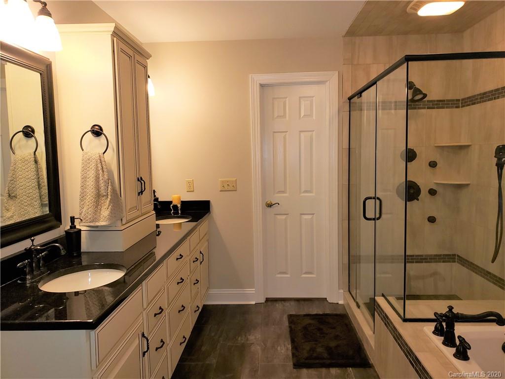 121 Spring Branch Road Fort Mill, SC 29715 - Photo 13 of 17 a bathroom with a double vanity sink a mirror and a shower