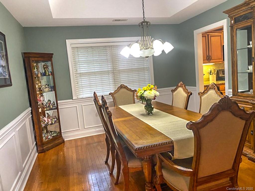 121 Spring Branch Road Fort Mill, SC 29715 - Photo 8 of 17 a view of a dining room with furniture wooden floor and chandelier