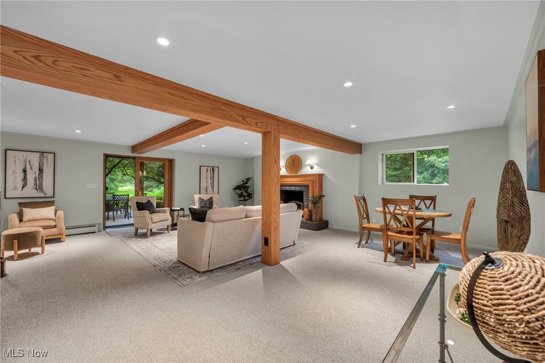 13962 Quarry Road Oberlin, OH 44074 - Photo 19 of 43 Living area with healthy amount of natural light, recessed lighting, a fireplace with raised hearth, beamed ceiling, and baseboard heating