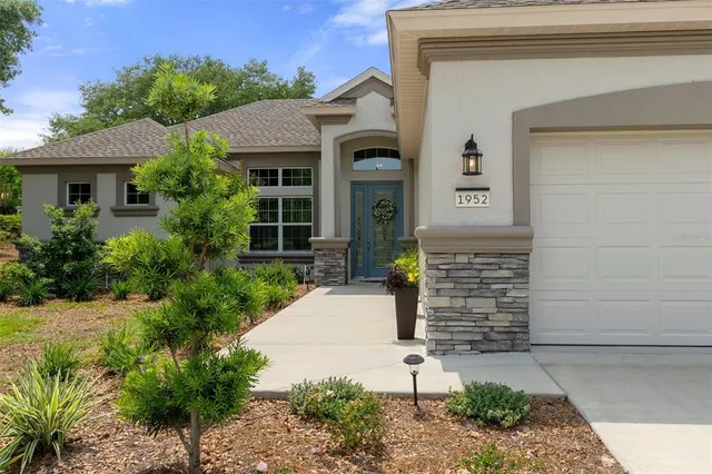 a front view of a house with a garden