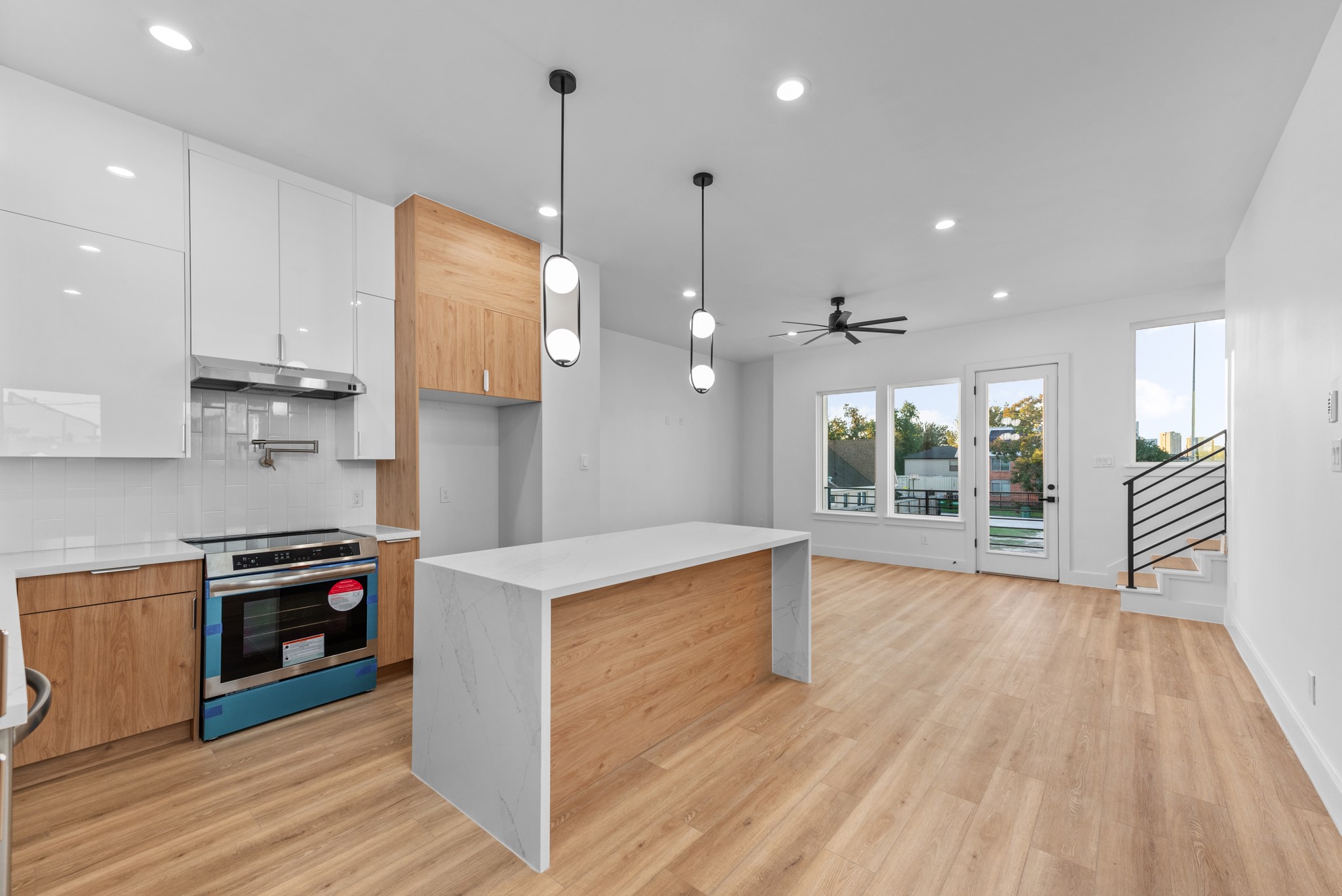 2314 Barbee Street Houston, TX 77004 - Photo 13 of 15 a kitchen with stainless steel appliances granite countertop a sink a stove and a wooden floors